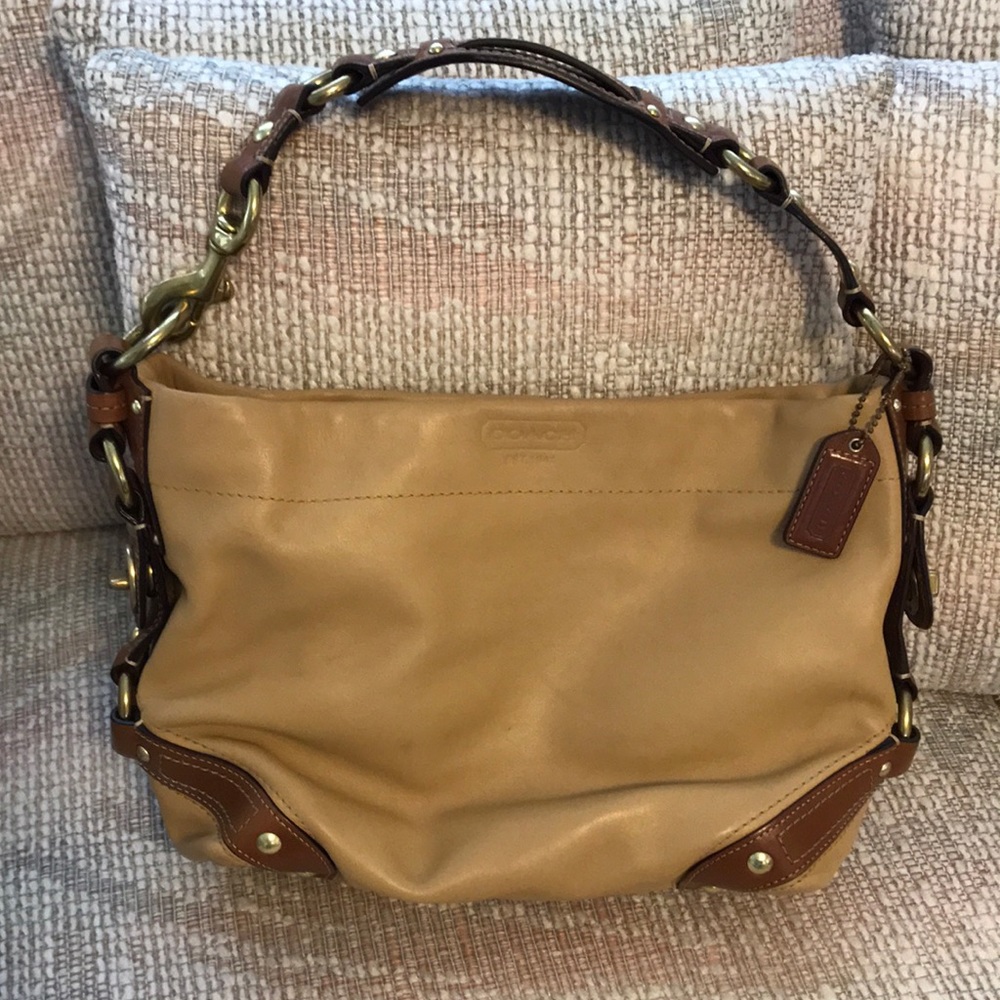 Vintage Coach. Tannish color. Lots of hardware.